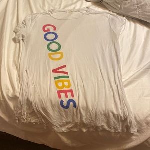 White shirt with rainbow letters that say GOOD VIBES